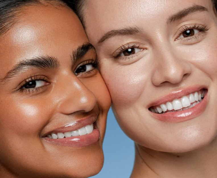 Two women with clear, glowing skin