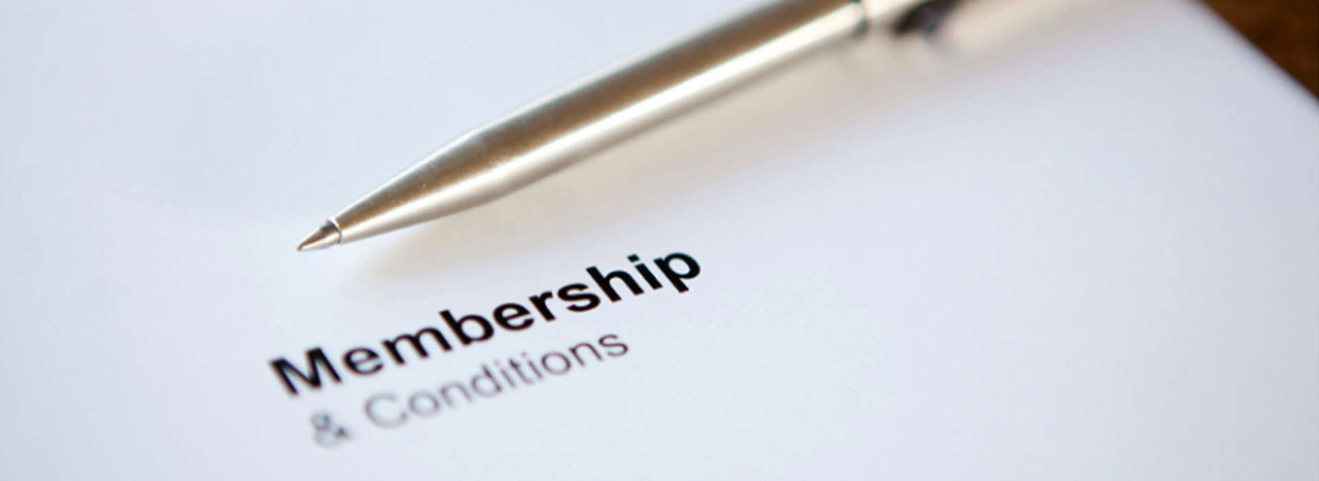 Close-up of a pen and membership form for wellness services.