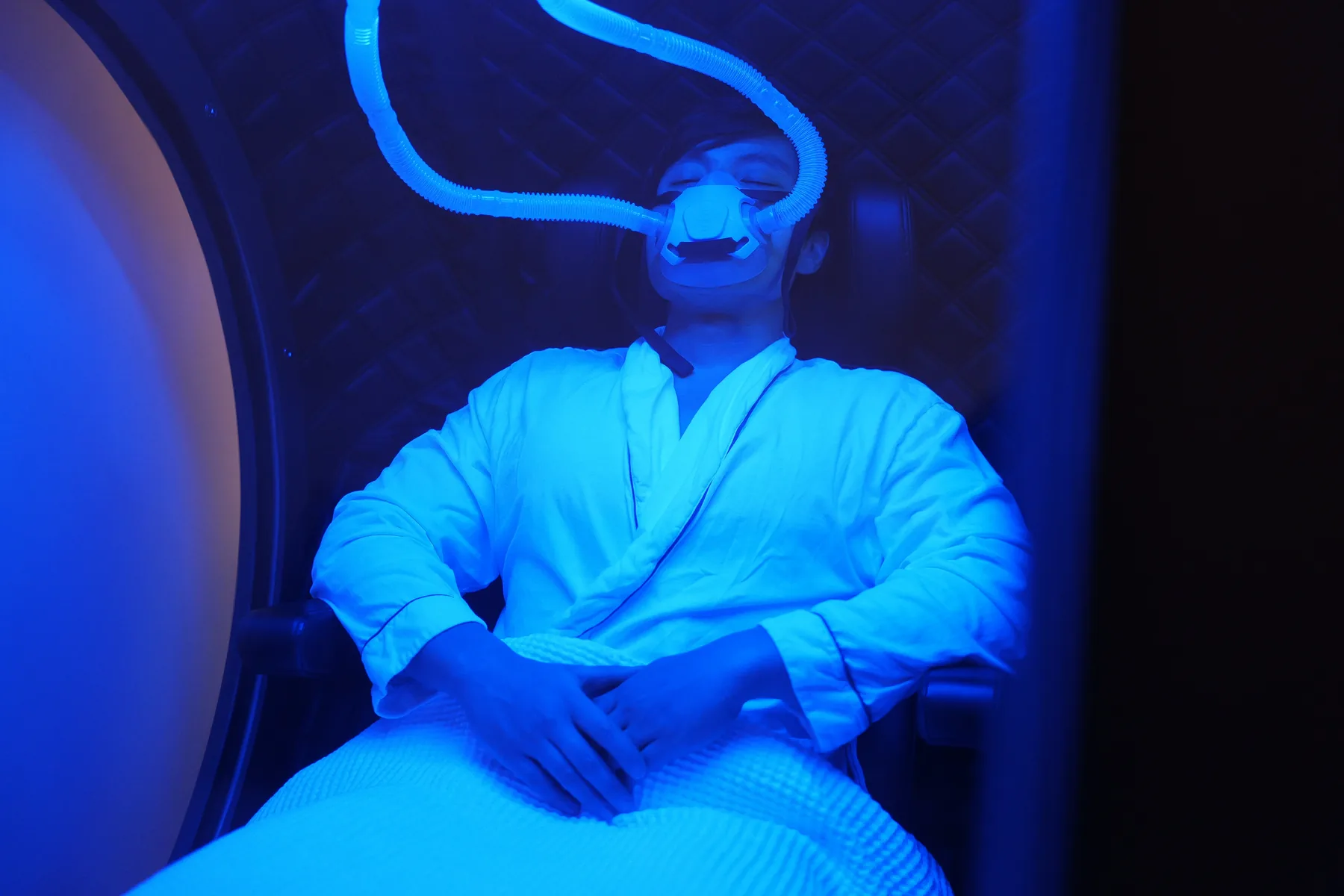 Patient relaxing inside the hyperbaric oxygen chamber at Balanced Aesthetics + Wellness in Brookhaven